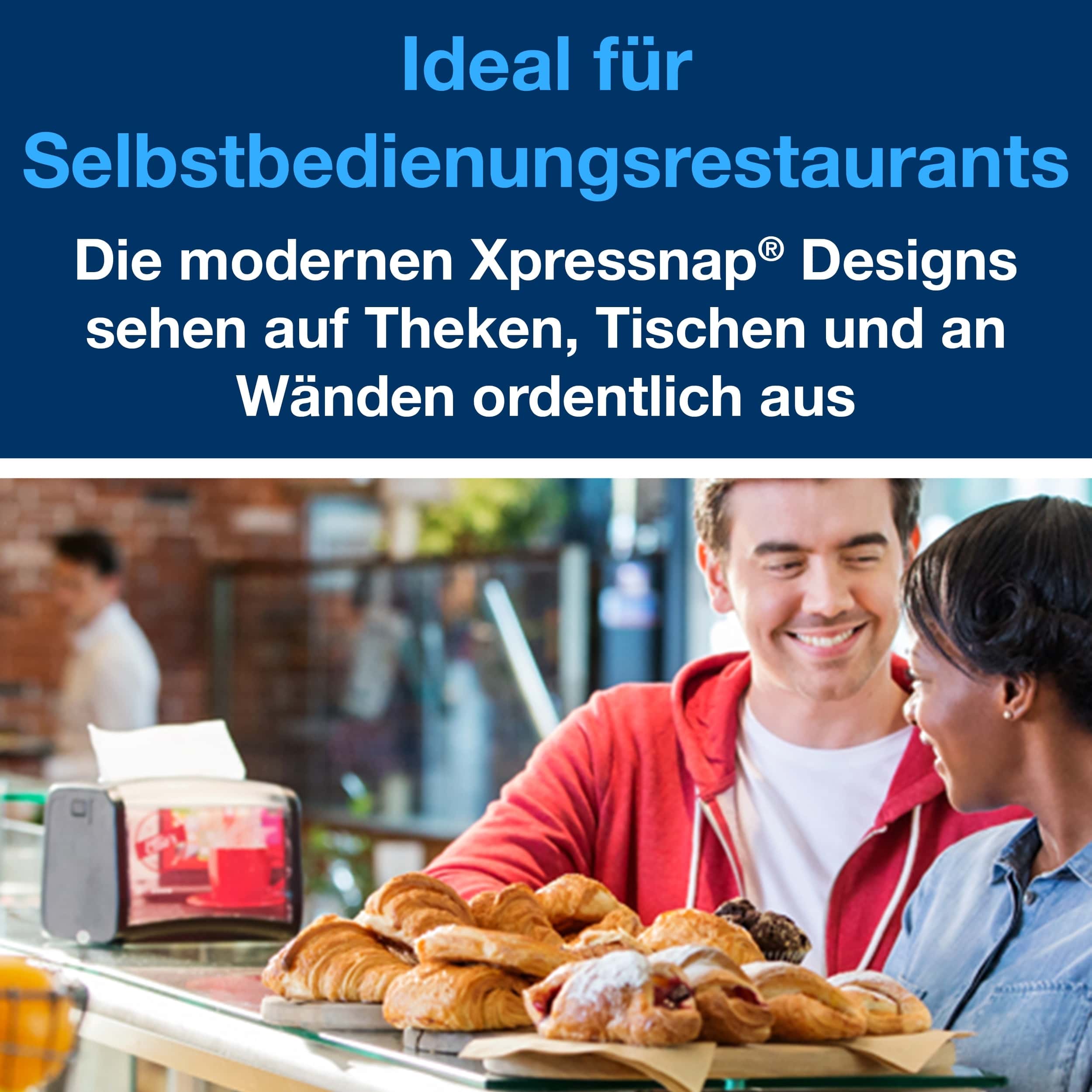 Tork Xpressnap Spender mit Gebäck Mann und Frau lächeln an einer Theke mit Gebäck und einem Tork Xpressnap-Spender.